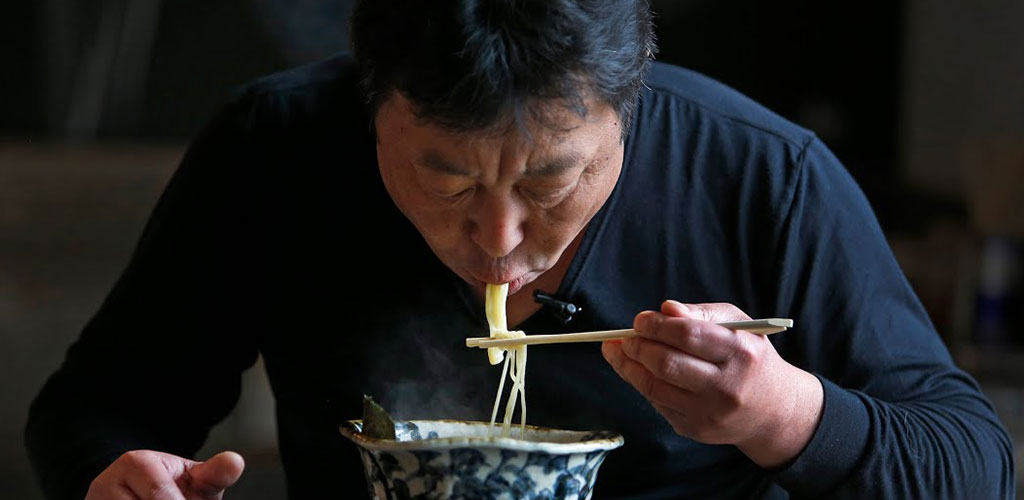 Man Eating Noodles with Chopsticks